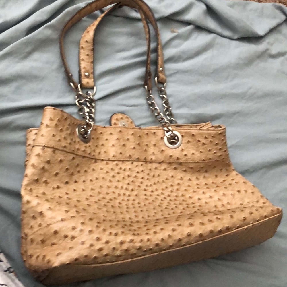 A tan and brown shoulder purse.